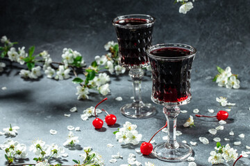 Cherry wine or liquor, fresh berries and blossoms, Berry alcoholic drinks concept