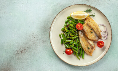 Roasted tilapia fillet with vegetables. Healthy food concept. place for text, top view