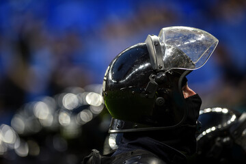 Riot police officers helmets with visors are seen during a protest