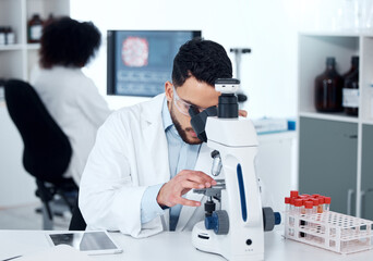 Fototapeta na wymiar Science, particles and scientist analyzing with a microscope in a medical laboratory with concentration. Biotechnology, pharmaceutical and male researcher working on scientific project for healthcare