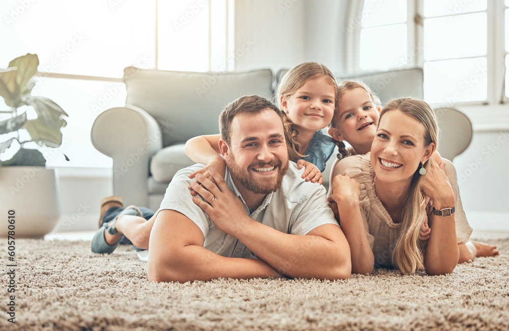 Wall mural Portrait of mother, father and children on living room floor for bonding, quality time and playing together. Happy family, smile and mom and dad with girls for care, love and relax at home on weekend