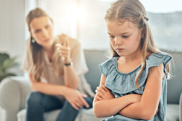 Angry lecture from mom, sad child and discipline in living room, problem with naughty girl behaviour in home. Scolding, punishment and frustrated mother, stubborn kid and communication with anger. - obrazy, fototapety, plakaty
