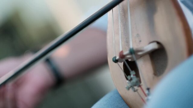 musician playing the stringed fiddle. kemenche master