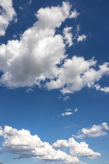 Storm clouds forming against blue sky.