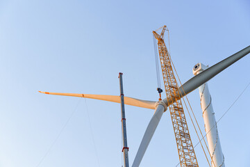 Wind turbines being hoisted and under construction