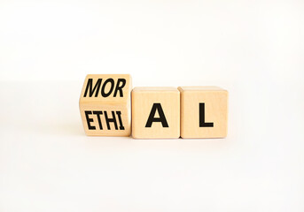 Ethical or moral symbol. Businessman turns wooden cubes and changes the word Ethical to Moral on a Beautiful white table white background. Business and ethical or moral concept. Copy space.
