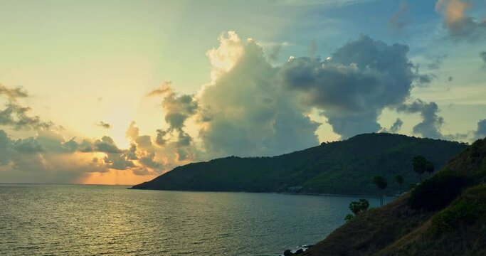 stunning sunset above the island in front Yanui beach..Yanui beach is in the middle of wind turbine viewpoint and Promthep cape small island in front of Yanui beach..creative nature and travel concept