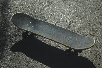skateboard and skateboard shadow on the ground on a sunny day © Jimmy