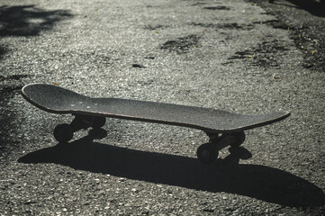 skateboard and skateboard shadow on the ground on a sunny day © Jimmy