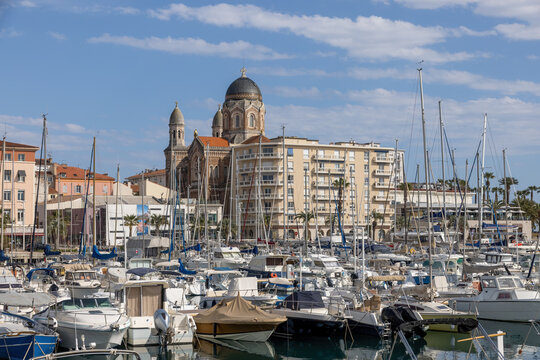 Saint Raphael looking across the harbor with yachts at Basilique Notre-Dame-de-la-Victoire in spring on the Cote d'Azur in France