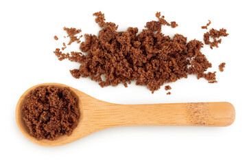 Dark muscovado sugar or Barbados sugar in wooden spoon isolated on white background. Top view. Flat lay