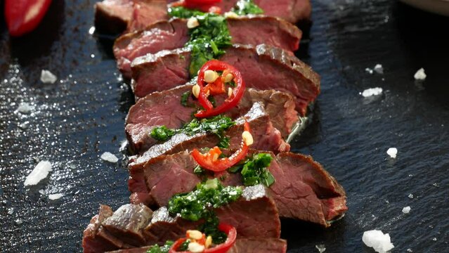 Black stone plate with skirt steak pepper and chimichurri sauce