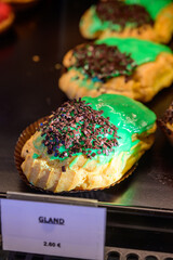 Assortment of french fresh baked sweet pastry with chocolate in confectionery shop in Paris, english translation is glans cake