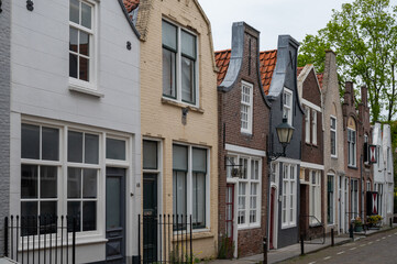 Naklejka premium Walking in old Dutch town Zierikzee with old small houses and streets, Zeeland, Netherlands