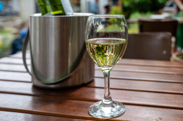 Drinking cold white wine on outdoor terrace, summer vacation, close up