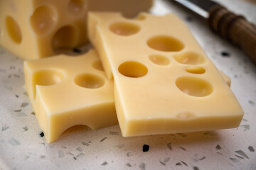 Cheese collection, french hard cheese with holes emmentaler close up