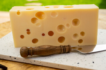 Cheese collection, french hard cheese with holes emmentaler close up