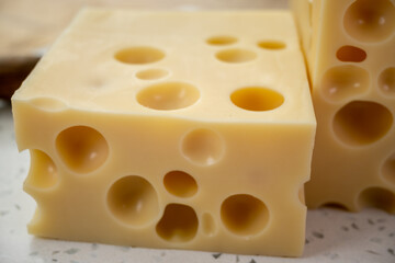 Cheese collection, french hard cheese with holes emmentaler close up