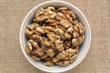 Walnut on eco canvas napkin background. Healthy eating diet, nutrition, vegan concept. Protein organic food. Dry snack. National nut day. Copy space for text