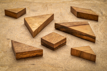 seven tangram wooden pieces, a traditional Chinese puzzle game, texture bark paper background