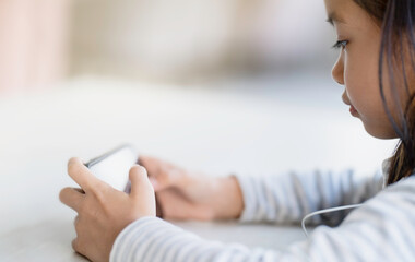 A girl is using a smartphone, learning for new generations of children.