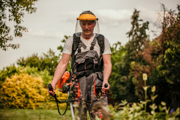 Man cutting the grass with power mower