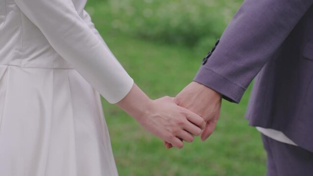 bride and groom holding hands