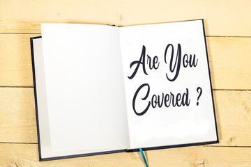 Are You Covered? Insurance concept on notebook