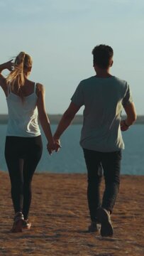 The happy couple walking on the mountain near the sea. slow motion