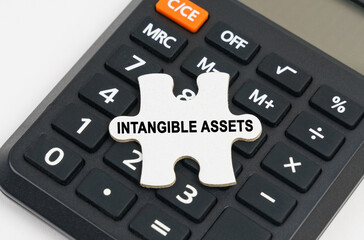 On the calculator is a puzzle with the inscription - Intangible assets