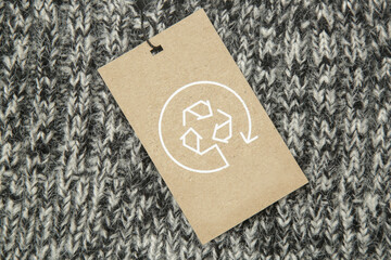 Close up of clothing tag with recycle icon. Recycling products concept. Zero waste, suistainale...
