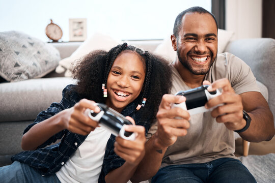 Naklejka Gaming, family or children with a father and daughter in the living room of their home playing a video game together. Kids, happy or fun with a gamer dad and girl child in the house to play online
