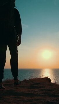The man and woman with backpacks hiking near the sea. slow motion