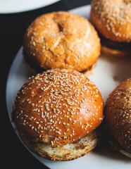 Process of cooking and grilling beef burgers on open-air street food festival, view of chef hands in gloves with variety of ingredients on grill stove, family burger picnic at summer terrace