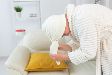 Woman make wrapped in a towel drying her hair after a morning shower. Hair care and body skin...