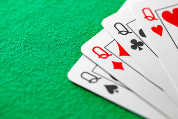 Poker combination quads - four cards of the same value queen, selective focus