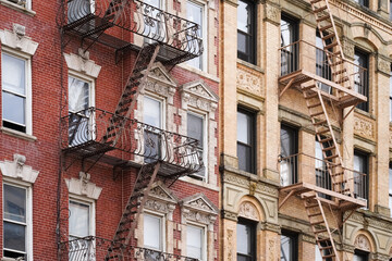 Beautiful classic New York City apartment building exterior with ornate window details and fire...