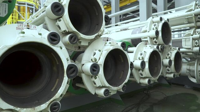 Riser pipes on offshore drilling platform. Risers are stacked on top of each other