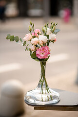 Beautiful mix of eustoma flovers and green eucalyptus in transparent vase