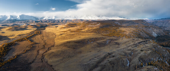 Autumn landscape with views of mountains, forest, road, steppe, river, lake, yellow leaves and trees