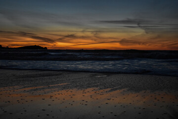 Fototapeta na wymiar Beach sunset orange skies sea landscape