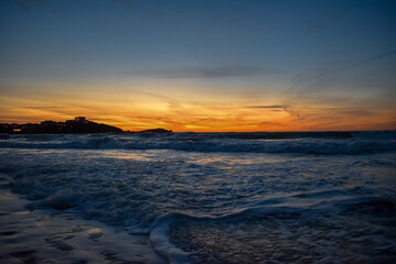 Fototapeta na wymiar Beach sunset orange skies sea landscape