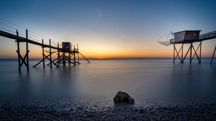 Fishing hut on stilts coast of Atlantic ocean at sunset near La Rochelle, Charente Maritime, France