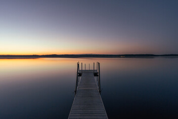 calm lake at sunset with jetty - 605816090