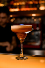 Espresso martini cocktail with vodka, coffee liqueur, syrup and ice on bar counter