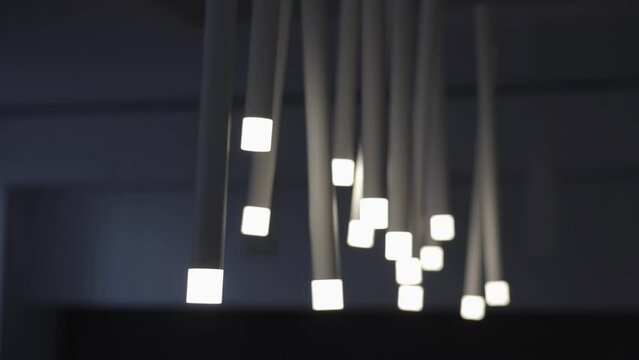stylish lamps with tubes and lightbulbs swing on celling
