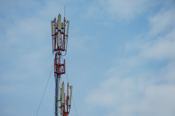 New GSM antennas on a tower against a blue sky for transmitting a 5g signal are dangerous. Radiation pollution of the environment through cell towers. New technologies in the field of communication.