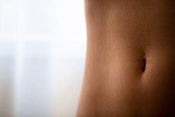 Close up of perfect abdominal muscles of fitness woman