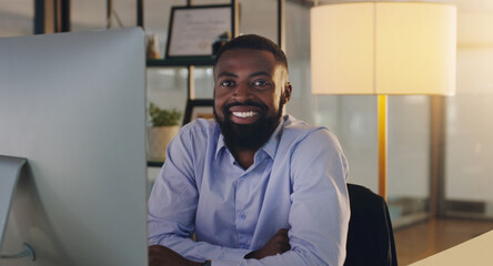 Black man, business and portrait in night, office and smile with computer, pride and arms crossed....