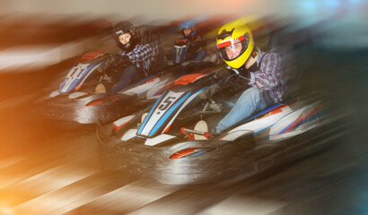 positive people driving sport cars for karting in a circuit lap in sport club